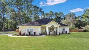 A single-story house with a front porch, a well-maintained lawn, and a mailbox. - Savannah 5BR Pool, Jacuzzi, Firepit, Sports, Games (Savannah)