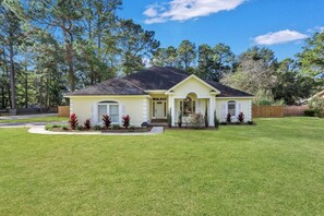 A single-story house with a front porch, a well-maintained lawn, and a mailbox.