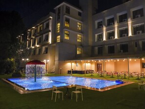 A hotel with a swimming pool, outdoor seating, and a building with multiple floors and windows. - The Metropole by Keyboard Hotels (Mawal)