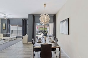 Dining Area- with comfortable seating, stylish decor, and a warm ambiance, it sets the stage for delightful culinary experiences and cherished moments of togetherness. - Pool Home: 4BR w/ Free Parking near Disney (Kissimmee)