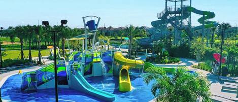 Parque acuático con múltiples toboganes y una amplia zona de juegos de agua.