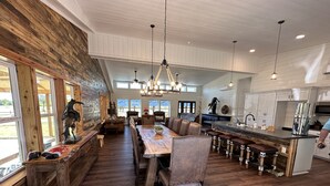 A spacious kitchen with a long island, wooden accents, and a rustic aesthetic. - Welcome to our picturesque ranch oasis less than 1 hour from DFW!  (Cleburne)