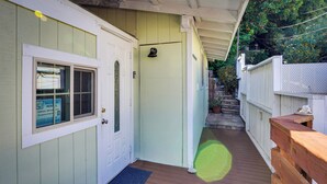 A wooden deck leading to a door with a 'Vacation Rental' sign, a mailbox, and a small step leading to a covered area. - Avalon Cottage < Half-mi to Beaches & Crescent Ave (Avalon)