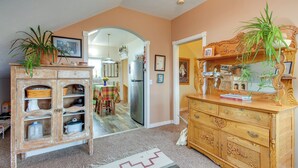 A kitchen with a wooden cabinet, a refrigerator, and a dining table with chairs. - Charming Livingston Vacation Rental w/ Views! (Livingston)