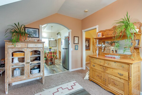 A kitchen with a wooden cabinet, a refrigerator, and a dining table with chairs. - Charming Livingston Vacation Rental w/ Views! (Livingston)