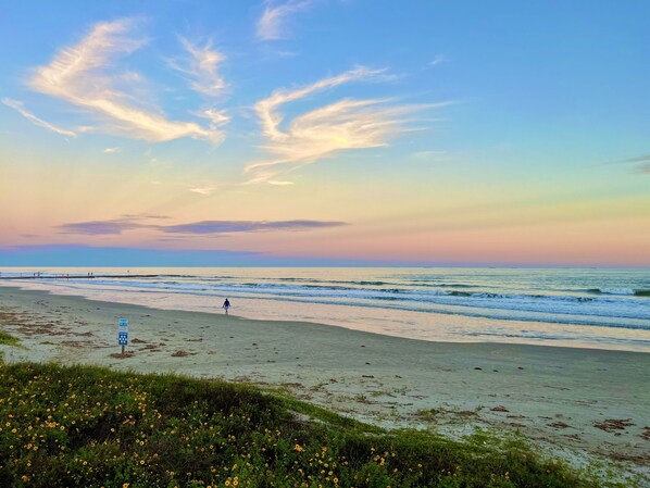 A beach with a clear sky and waves. -  Beautiful Home : Gulf views : Short Walk to Beach. Base rate 2 ppl (Galveston)