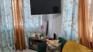 Comfort Apartment, 1 Queen Bed with Sofa bed | Living area | 50-inch Smart TV with cable channels