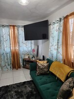 Comfort Apartment, 1 Queen Bed with Sofa bed | Living area | 50-inch Smart TV with cable channels