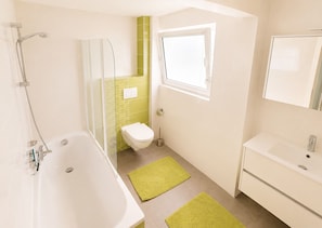 Une salle de bain avec une baignoire, des toilettes et un lavabo.