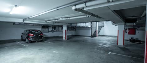 A parking garage with a car parked in one of the spaces.