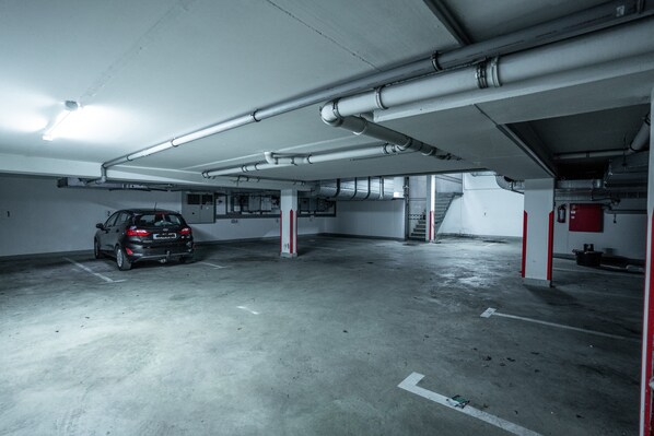 A parking garage with a car parked in one of the spaces.