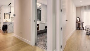 A modern apartment with a kitchen, a bathroom, and a bedroom.
