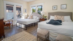 A bedroom with two beds, a ceiling fan, and a view of the outside. - Brand New Craftsman 2BR/2BA Home in Denver Heights (San Antonio)