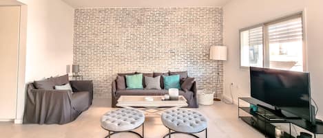 Apartment | Living area | 65-inch Smart TV with cable channels