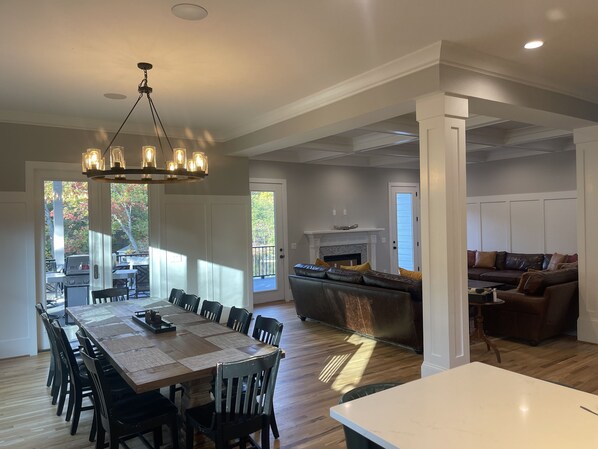 A spacious kitchen with a dining area, a fireplace, and a seating area with a couch.