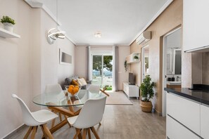 A modern apartment with a dining area, kitchen, and a balcony with a view. - Apartment With Lovely Views in Ciudad Quesada (Ciudad Quesada)