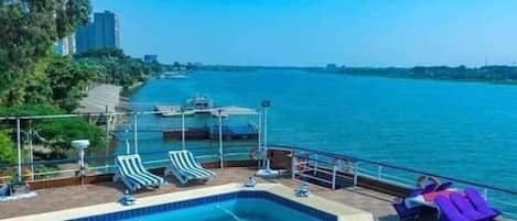 Outdoor pool, open 7:00 AM to 4:00 PM, pool umbrellas, sun loungers