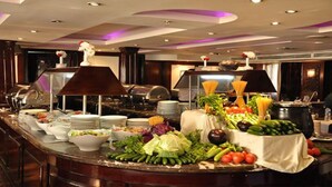 A buffet setup with various food items and utensils.