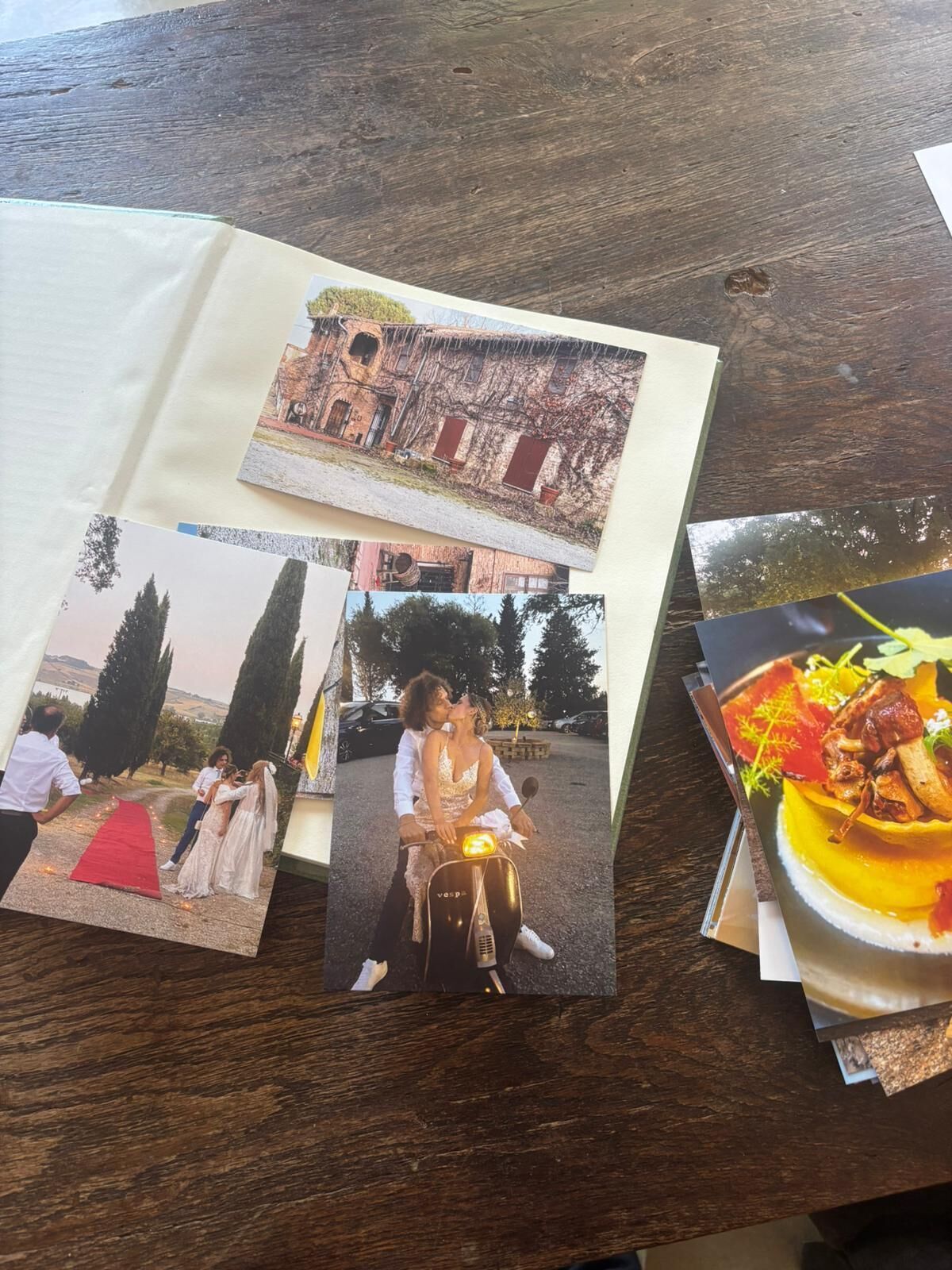 A wooden table with a photo album and a menu.