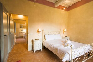 A bedroom with a bed, bedside tables, and a nightstand.