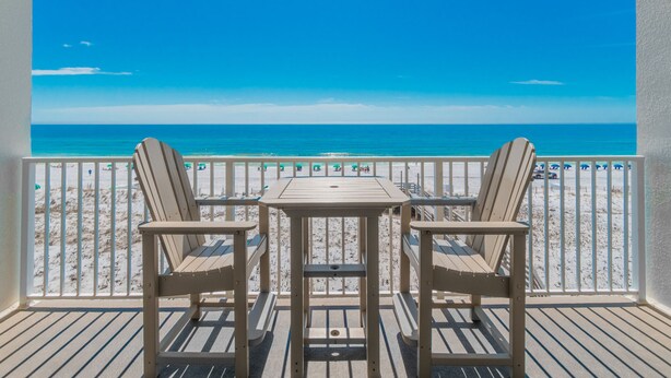 Een balkon met uitzicht op het strand en de oceaan.