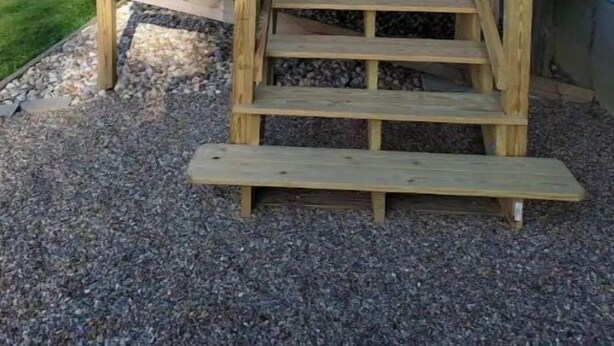 A wooden deck with a staircase leading to a covered porch area. - Blue Elephant Cottage (Sullivan)