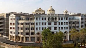 A multi-story building with a classical architectural style, featuring arched windows and a central dome. - Changsheng Hotel  (Jiangmen)