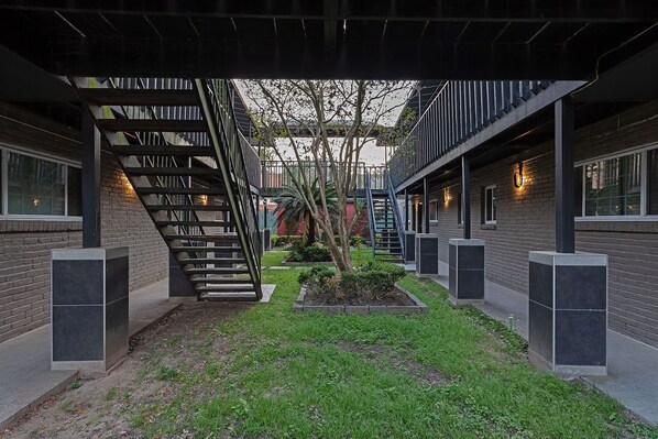 Stunning courtyard with a central staircase and lush greenery.