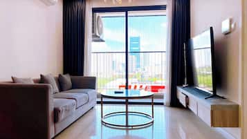 Two Bedroom Apartment | Living area | 50-inch LED TV with cable channels, pay films