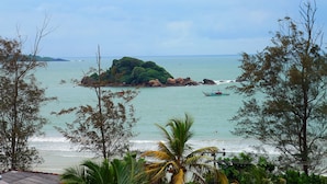 A coastal view with a small island, clear sky, and calm sea. - Mzion Hotel Weligama (Weligama)