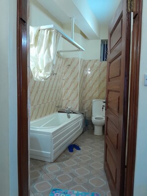 Deluxe Double Room | Bathroom | Slippers - Blue Star Apartments (Entebbe)