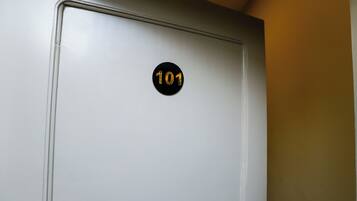 A door with a number plate indicating room 101.