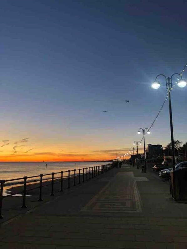 Stroll along the oceanfront promenade, bordered by a low fence and offering breathtaking views of the sea.
