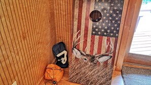 A wooden door with an American flag design and a deer head.