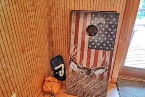 A wooden door with an American flag design and a deer head.