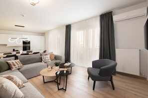 Deluxe Apartment (Athens Hills C) | Living area | 50-inch Smart TV with cable channels - Seven Hills, Boutique Apartments (Athens)