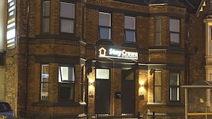 A brick building with a sign reading "The Crowe." - StayCrewe Apartments (Crewe)