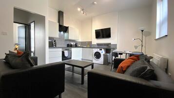 Executive Apartment | Living area | 42-inch flat-screen TV with digital channels