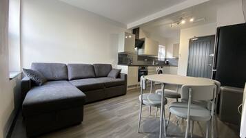 Executive Apartment | Living area | 42-inch flat-screen TV with digital channels