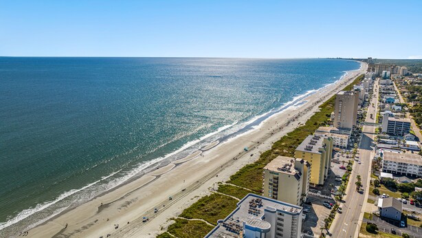 A coastal cityscape with a beach, high-rise buildings, and a clear sky. - Pet Friendly Private House w/Pool & Game Room + Free Attraction Tickets! (North Myrtle Beach)