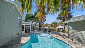 A swimming pool with a curved edge, surrounded by a brick patio. - Pet Friendly Private House w/Pool & Game Room + Free Attraction Tickets! (North Myrtle Beach)