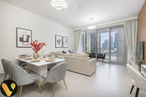 Elite Apartment | Living area | 65-inch Smart TV with cable channels, foosball