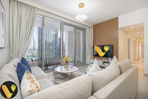 Elite Apartment | Living area | 65-inch Smart TV with cable channels, foosball