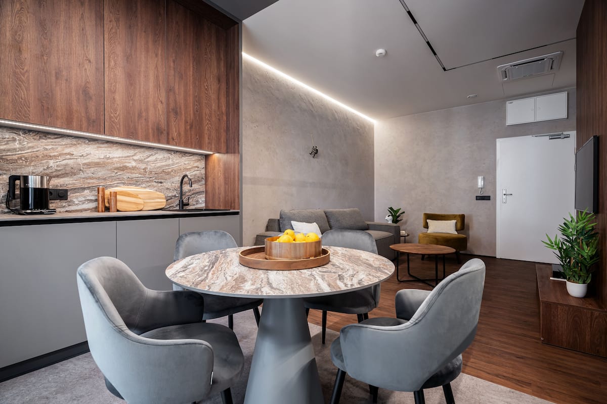 A modern interior with a kitchen, dining area, and seating space.