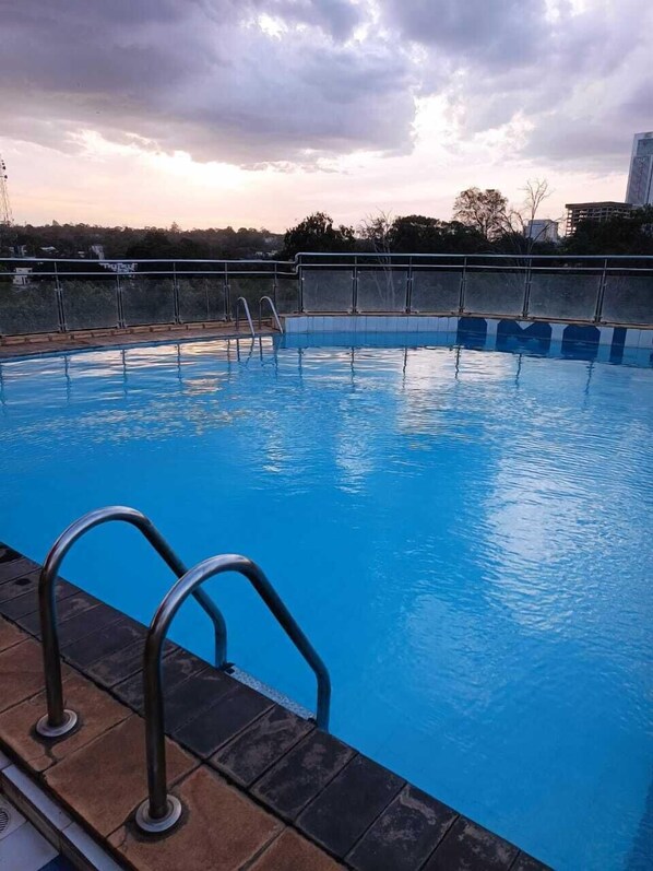 Enjoy a refreshing swim in the pool surrounded by a spacious deck with a secure handrail.