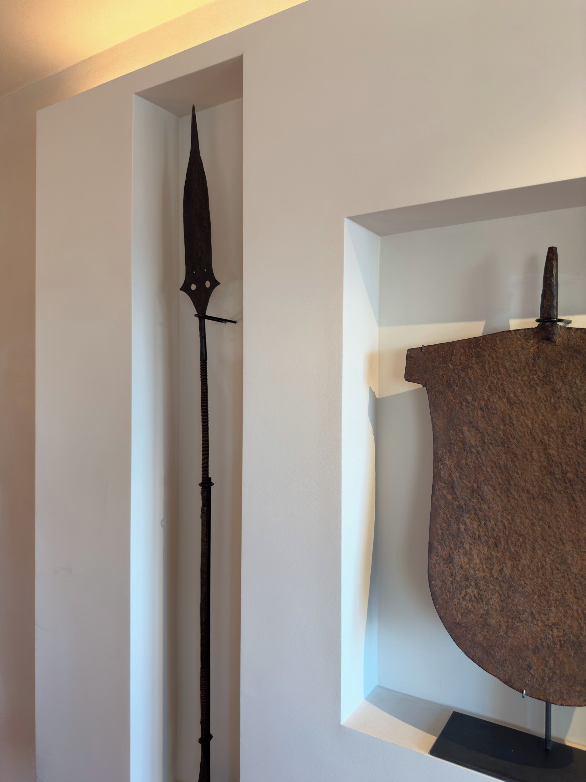 A display case containing a medieval sword and a shield.