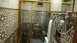 Un bagno con doccia vetrata, un water e un lavandino.