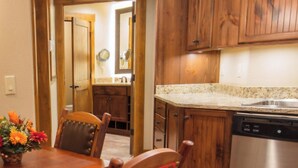 A kitchen with wooden cabinets, a stainless steel dishwasher, and a granite countertop. - Westgate Resort with beautiful mountain views, Smoky Mountain National Park (Gatlinburg)