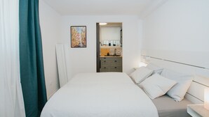 A hotel room with a bed, a nightstand, a mirror, a sink, and a window with curtains. - First love Apartment in Zagreb center (Zagreb)