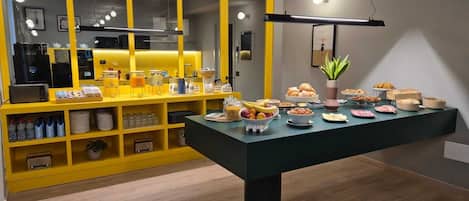 A breakfast buffet with various food items and a coffee station.